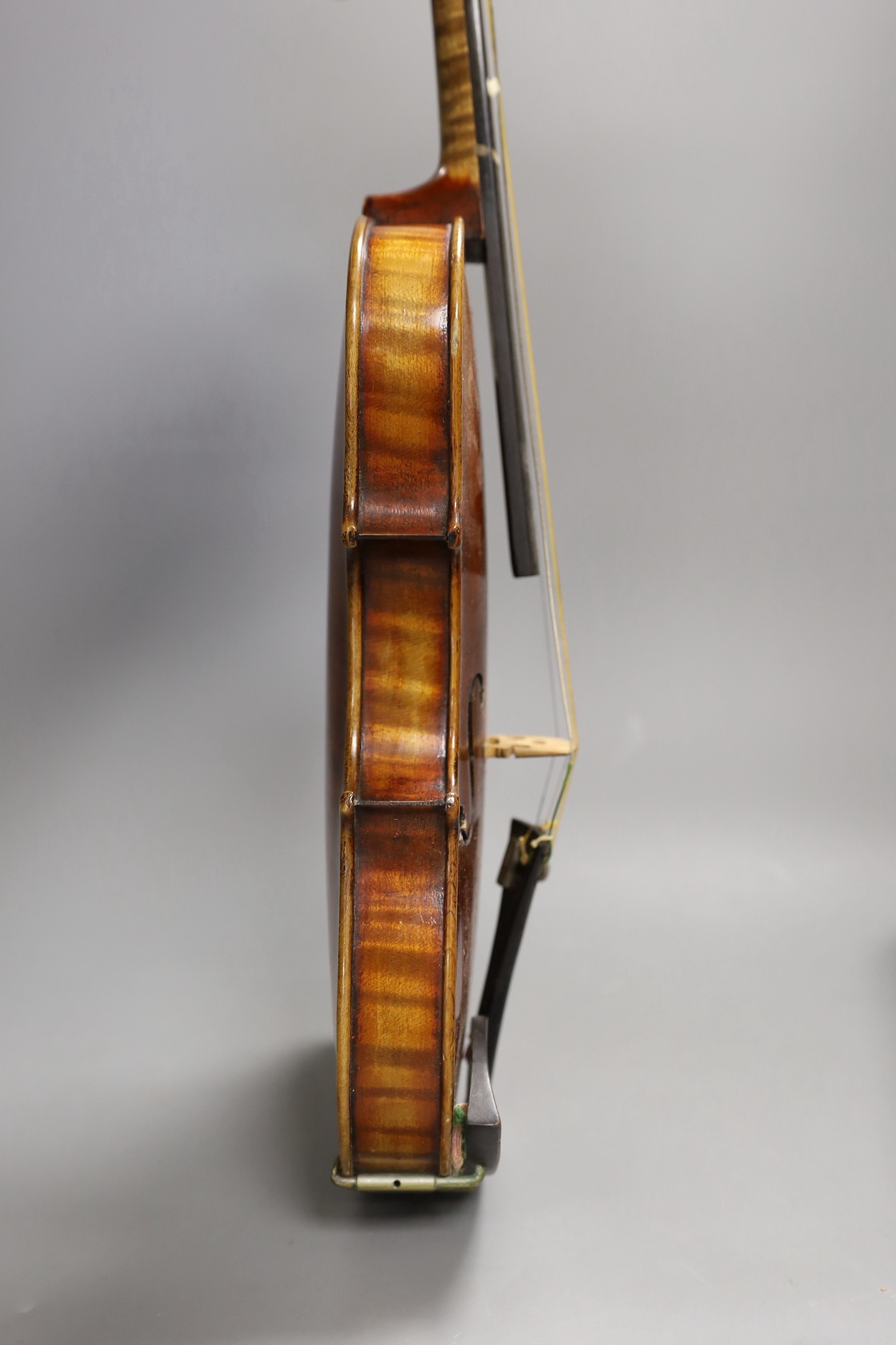 A quarter size late 19th century violin with bow, in E. Hill & Sons case, back measures 29cm